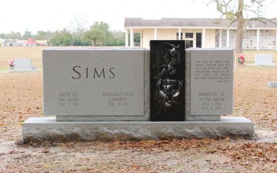 Brown Memorials - This modern design shows the Sims family's love of the outdoors.  The deer in the scene is a specific deer that Little David shot on one of his many hunting trips, and the natural (rustic) rock border represents their love of the mountains. The memorial was designed by Bran Oswalt (5th generation Brown) and hand etched by artist, Dan Garrison at their Florence facility. 